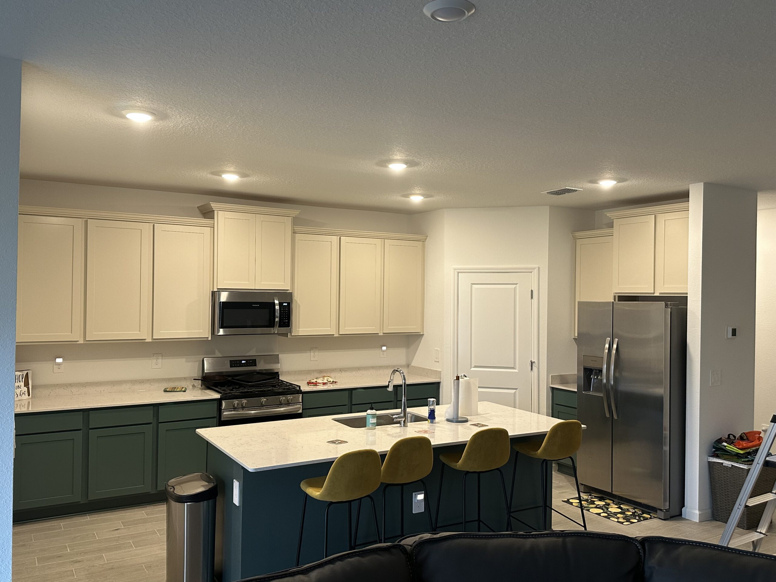 Two-tone kitchen &mdash; cream uppers, forest green island by Color Pros Painting