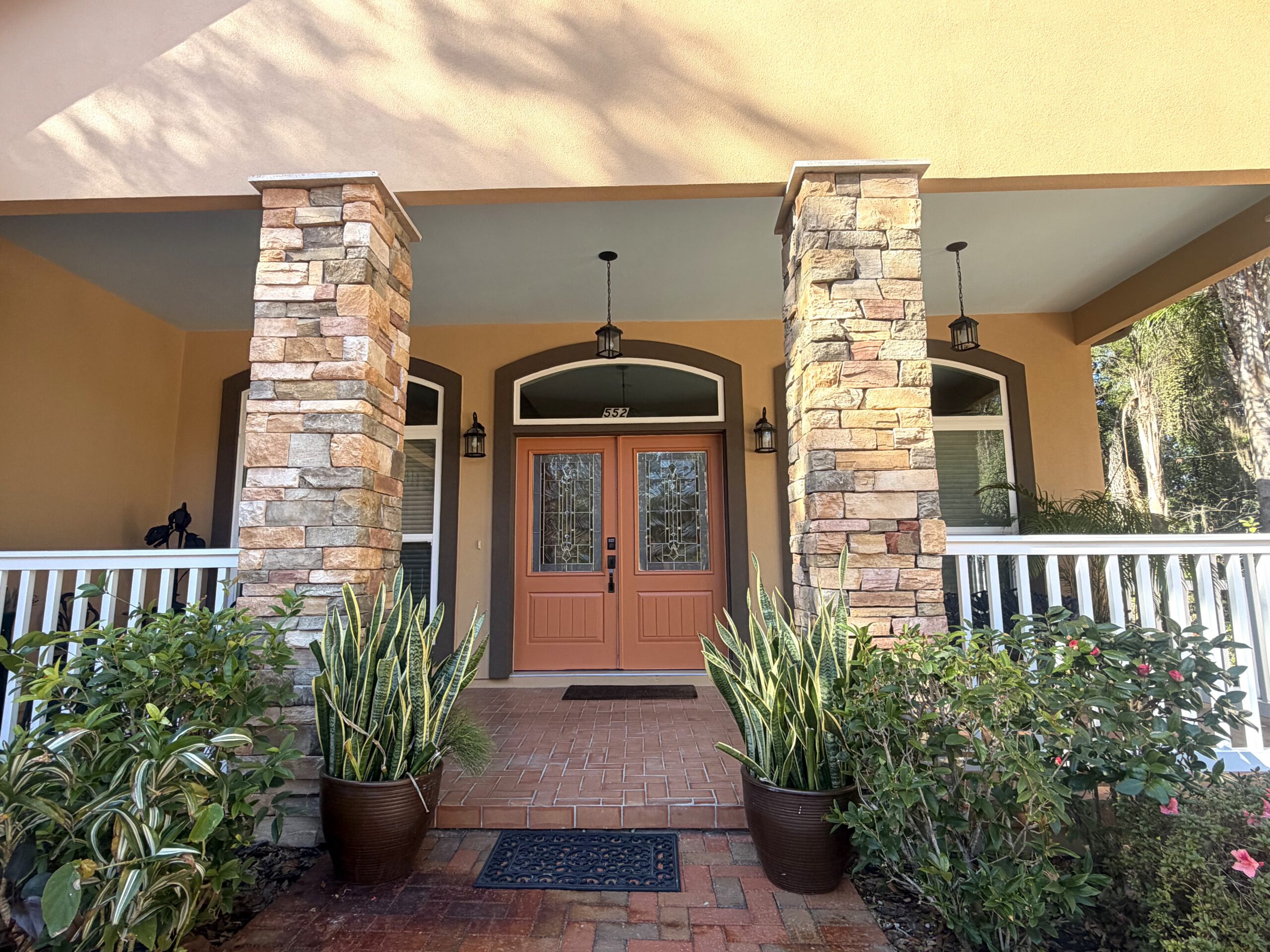 Custom entry &mdash; stained doors & stone columns by Color Pros Painting