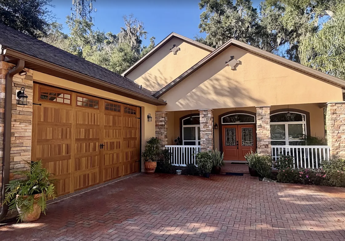 Full exterior repaint — stucco, stone and garage doors by Color Pros Painting